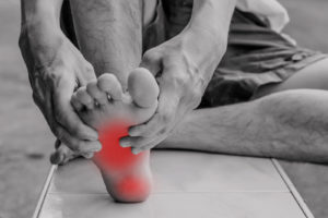 Man holding and massaging a foot injury