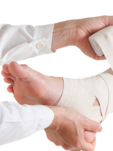 Doctor wrapping injured patient visitors foot