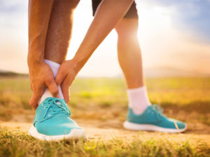 Running cradling ankle injury outdoors